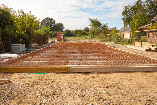 Reinforced concrete mats as a foundation for the construction of a prefabricated house.