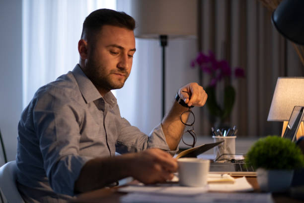istock Young man working at home in the evening 1344469972