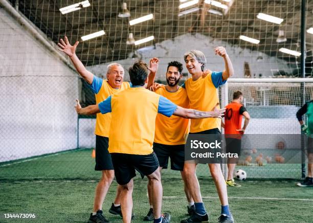 Successful Soccer Players Celebrating After Winning The Match Stock Photo - Download Image Now