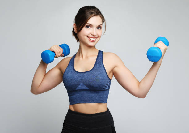 sport and people concept: Young girl athlete, fitness with dumbbells on white background stock photo