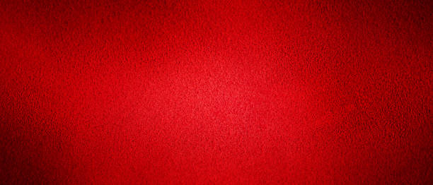 istock Red background natural suede with a dark edge and a light center. Horizontal web banner. 1344475958