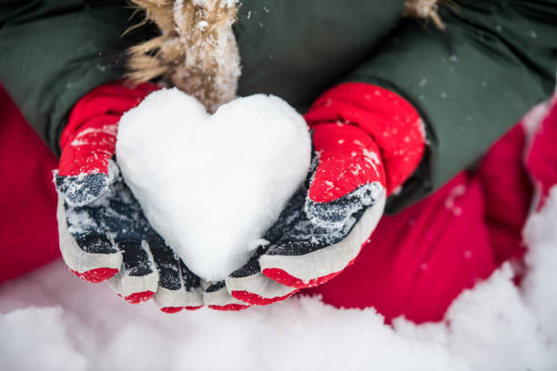 Girl holding an ice heart in bright red gloves Girl holding an ice heart in bright red gloves. february photos stock pictures, royalty-free photos & images