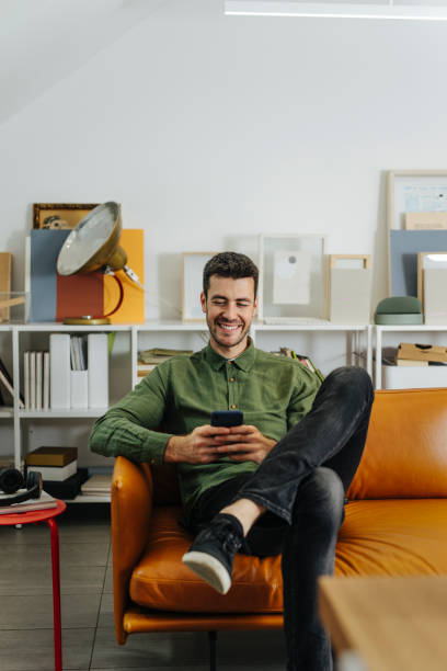 istock Handsome Businessman Typing Text Message on Mobile Phone in the Office 1344481472