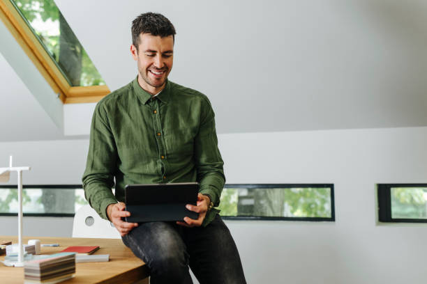 istock Happy Businessman Using a Digital Tablet in the Office 1344481487