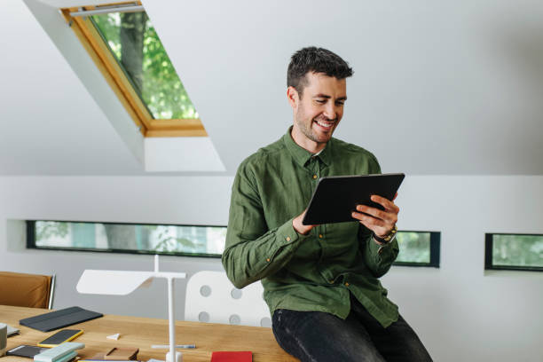 istock Happy Businessman Using a Digital Tablet in the Office 1344481489