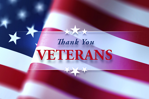 Thank You Veterans  message written over waving American flag with selective focus. Horizontal composition with copy space. Front view. US Veteran's Day  concept.