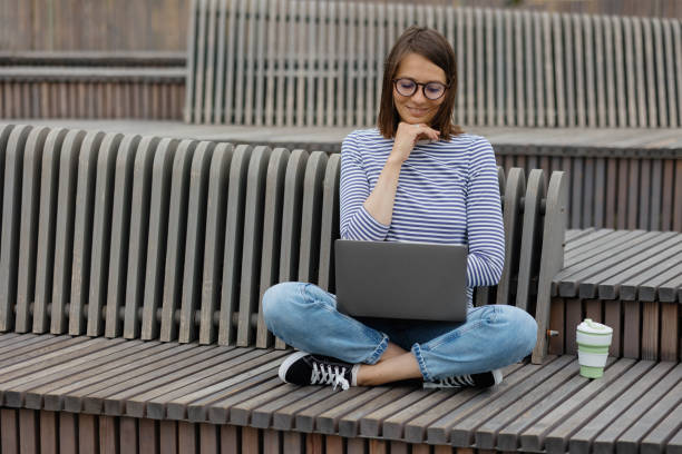 istock young and confident woman blogger or marketer drinking coffee and working on her laptop. work in a park or public place. social media or work as a top manager 1344494813