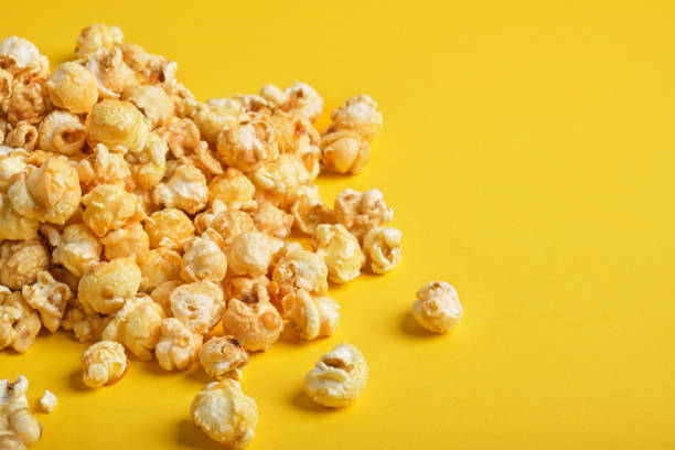 istock tasty caramel popcorn on a yellow background 1344496825