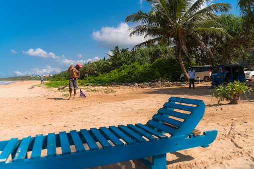 A young Sri Lankan man is working on a public beach in Aluthgama, Sri Lanka.