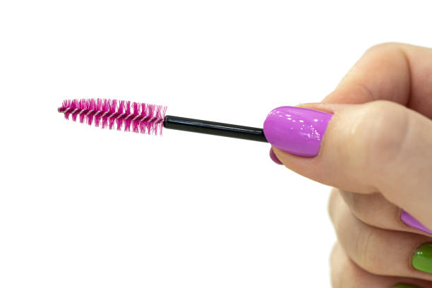 Hand holding pink brush for eyelashes and eyebrows isolated white background. Hand holding pink brush for eyelashes and eyebrows isolated on white background. mascara wands stock pictures, royalty-free photos & images