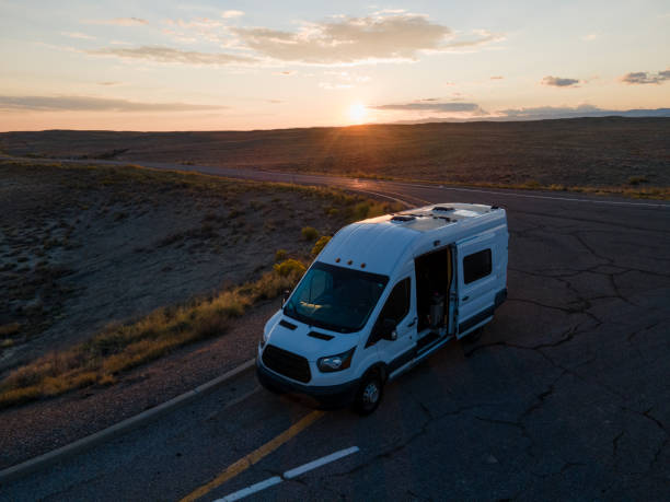 istock Camper Van in the desert on a highway in Utah at Dusk 1344502547