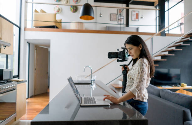 istock Young female influencer recording content at home 1344505068