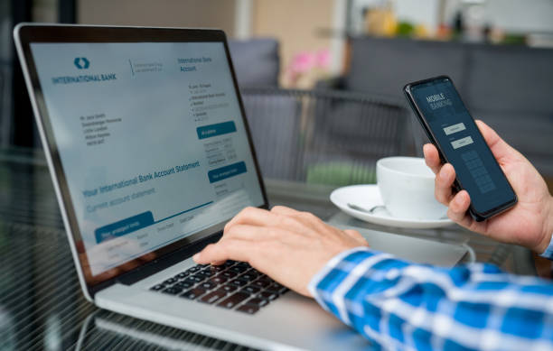 istock Close-up on a man paying bills online using a mobile banking app 1344505124