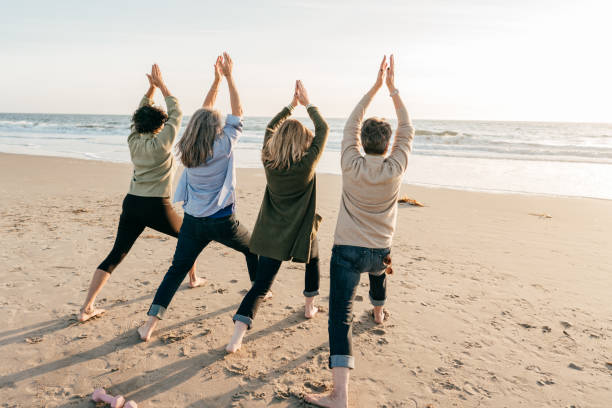 istock Yoga for seniors on the beach 1344505174