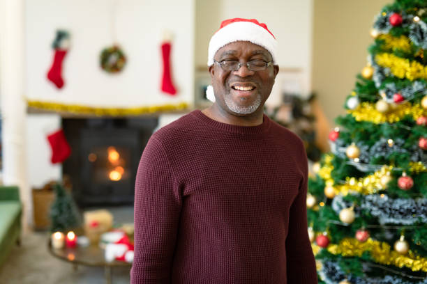 istock Happy african american senior man in santa hat looking at camera at christmas time 1344510607