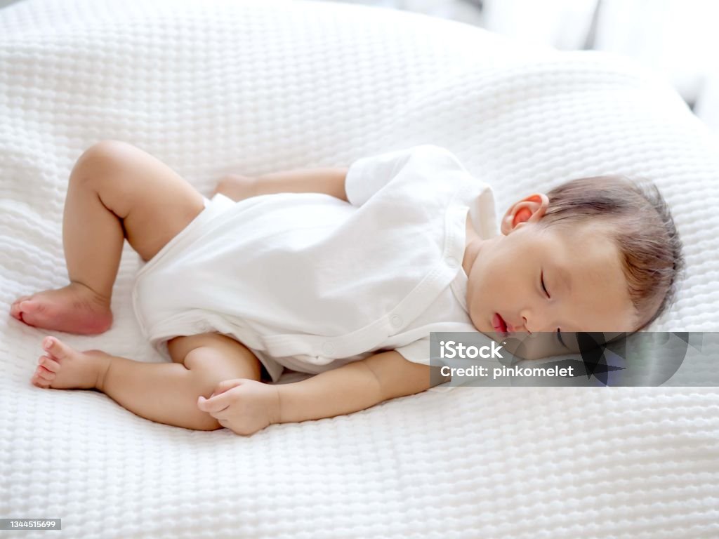 Close up sweet cute adorable Asian 3 months years old baby girl sleeping on white bed , newborn peace sleeping concept Close up sweet cute adorable Asian 3 months years old a baby girl sleeping on white bed , newborn peace sleeping concept Baby - Human Age Stock Photo