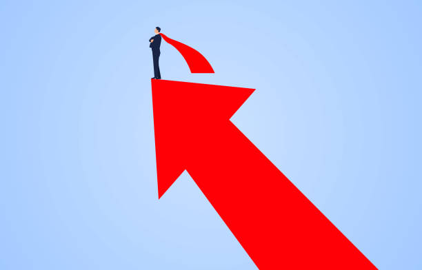istock Successful businessman wearing red cape standing on upward growing red arrow. 1344516263