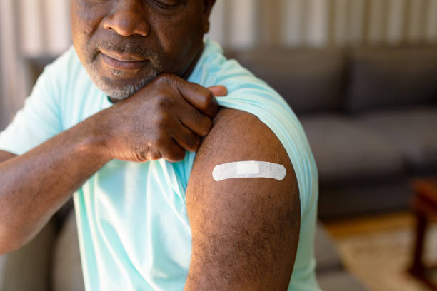 istock African american senior man showing plaster after vaccination 1344518225