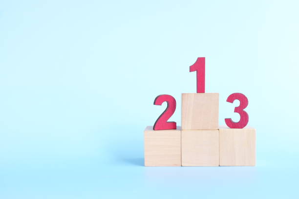 podium, ranking and hierarchy concept. wooden blocks with numbers 123 in blue background. - rank first place podium number 1 imagens e fotografias de stock