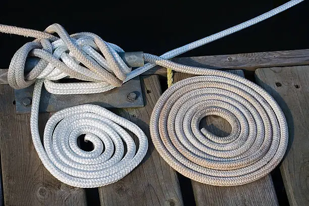 Coiled up sailing line on the dock.