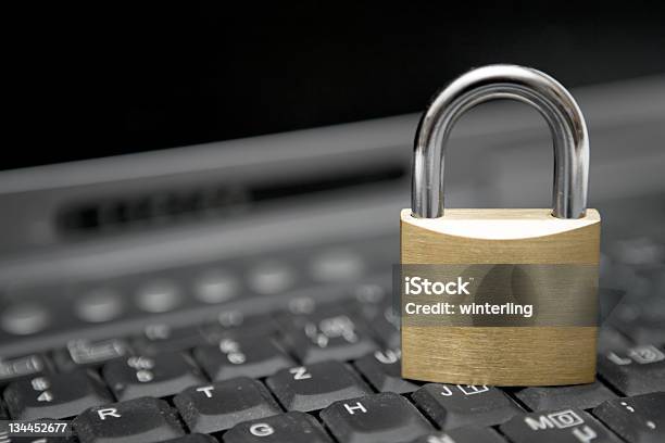 A Locked Padlock On Top Of A Computer Keyboard Stock Photo - Download Image Now - Accessibility, Close-up, Closed