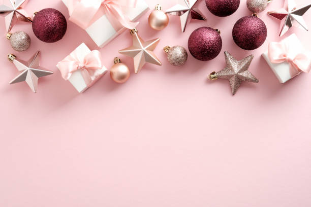 istock Modern Christmas background with gift boxes, balls, stars on pink. Flat lay, top view. 1344536318
