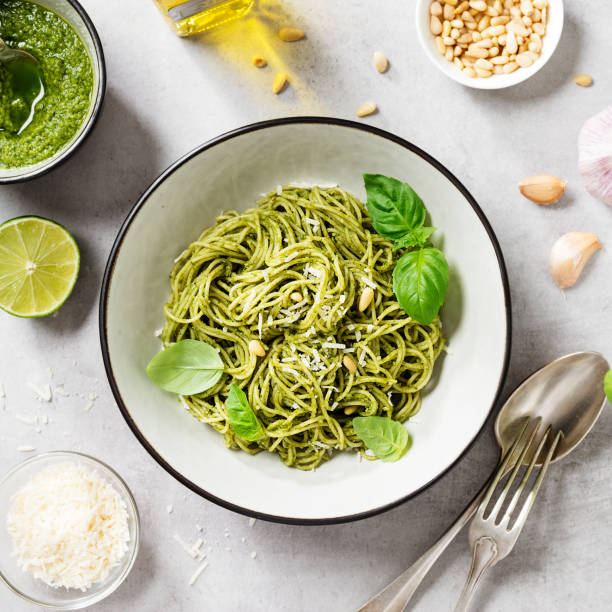 istock Pasta spaghetti with pesto sauce and fresh basil leaves 1344538219
