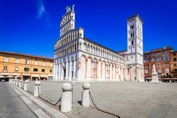 Lucca, Italy. Chiesa di San Michele in Foro - St Michael Roman Catholic church basilica on Piazza San Michele historical centre of old medieval town Lucca in summer day with clear blue sky, Tuscany.