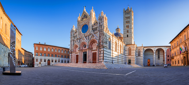 Siena, Italy. Beautiful view of facade and campanile of Siena Cathedral, Duomo di Siena at sunrise, Siena, Tuscany.