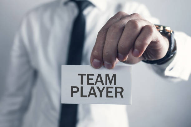 istock Male hand showing Team Player text on business card. 1344540322