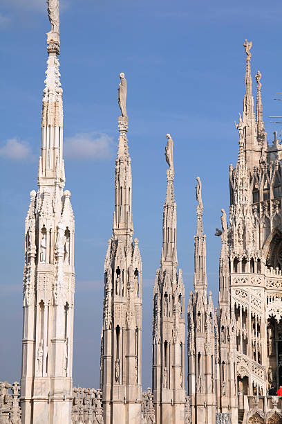 Milan cathedral Milan, Italy. Pinnacles of famous landmark - the cathedral made of Candoglia marble. candoglia marble stock pictures, royalty-free photos & images