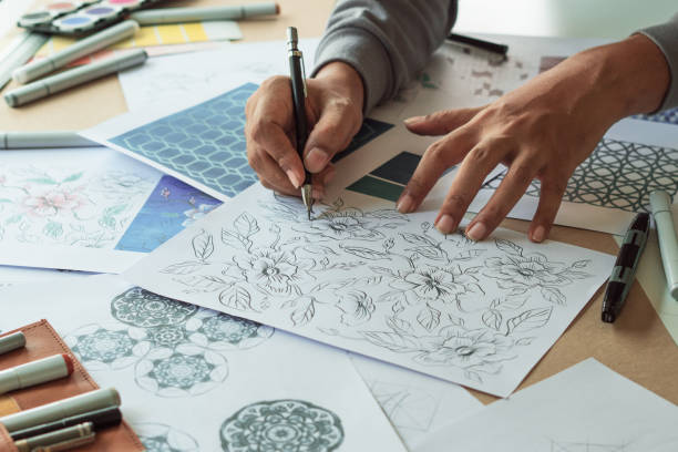istock Designer designing drawing sketch pattern geometric flower seamless wallpaper fabric textile fashion industry. artistic design studio. 1344542022