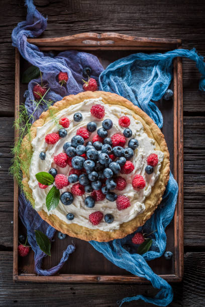 istock Fresh and tasty pie with mascarpone and berries 1344546904
