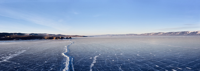 Frozen lake Baikal, at dawn. Winter landscape panorama
