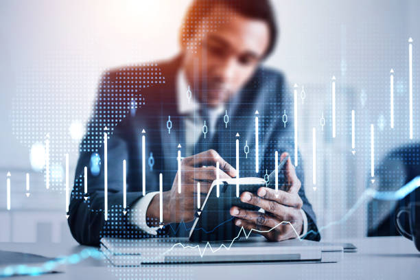istock African American trader wearing formal suit is sitting at workplace 1344550429