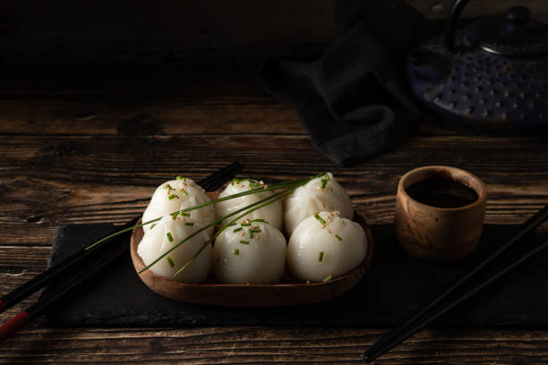 istock Steamed pork and prawn dim sum on slate stone on wooden table 1344551714