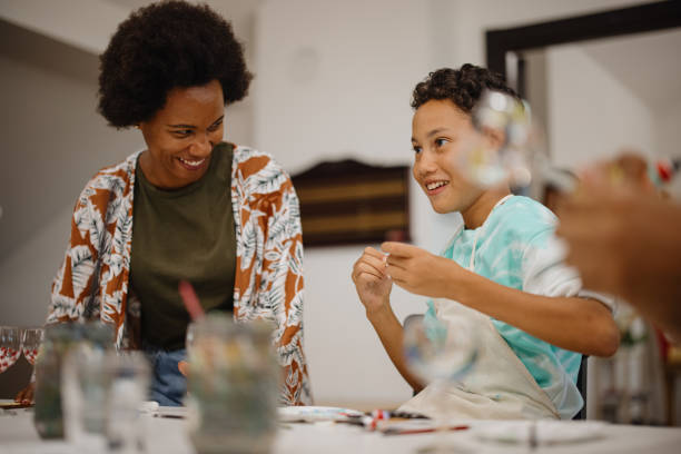 istock Art teacher having fun with little boy attending her class 1344551868