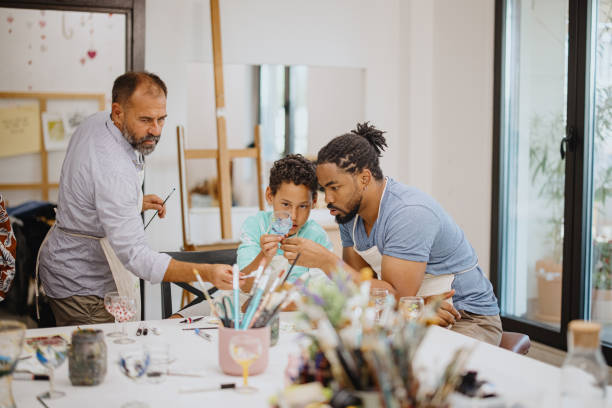 istock Father and son looking at wine glass they decorated together 1344552076
