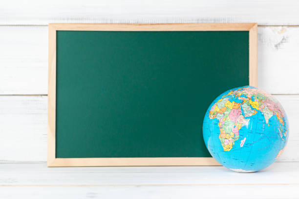 istock Greenboard with Globe sign on white wood background , empty board ,  education concept. 1344552900