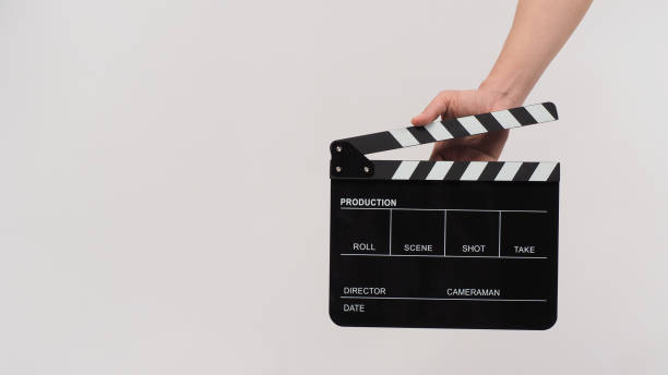 istock Hand is holding Black clapperboard or movie slate on white background. 1344552962