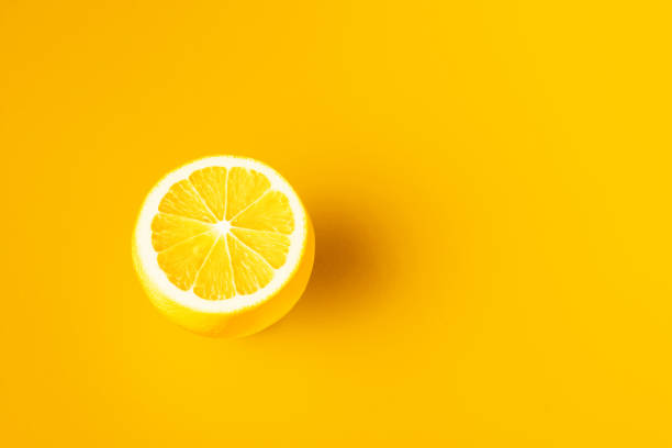istock Bright yellow lemon on a yellow background 1344555323