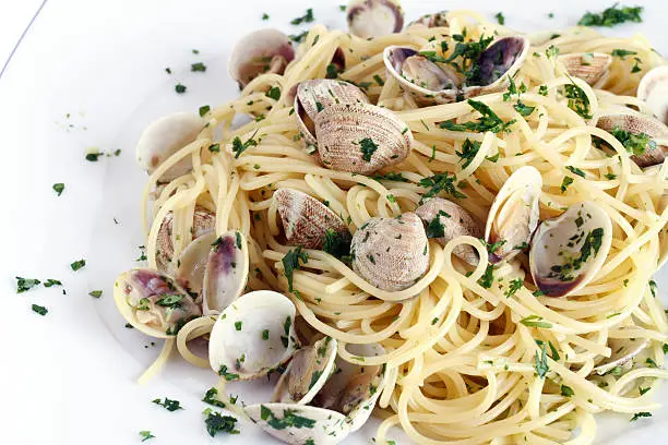 detail of dish with spaghetti, clams and parsley