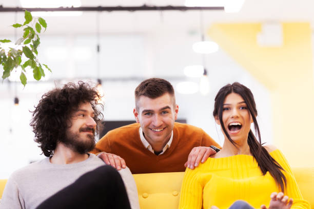 istock Three caucasian positive and happy colleagues in a modern office.. 1344556847