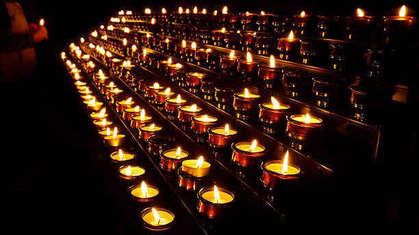 istock Lighting Prayer Candles in a Church 134455820