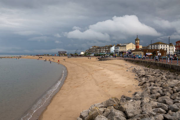 Morecambe Bay beach and promenade Editorial York, UK - September 25th, 2021: Morecambe Bay, a large estuary in northwest England, just to the south of the Lake District National Park, UK victorian swimwear stock pictures, royalty-free photos & images