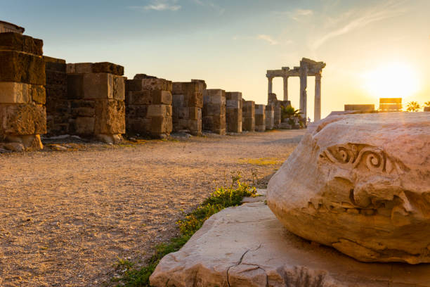 Panoramic view of ruins of ancient Temple of Apollo in Side on sunset, Alanya province, Turkey. Ruined old city. Unesco Cultural Heritage Monument. Panoramic view of ruins of ancient Temple of Apollo in Side on sunset, Alanya province, Turkey. Ruined old city. Unesco Cultural Heritage Monument. High quality photo temple of apollo antalya province stock pictures, royalty-free photos & images