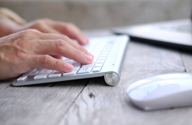 istock close up keyboard on wooden table and business concept 1344560782