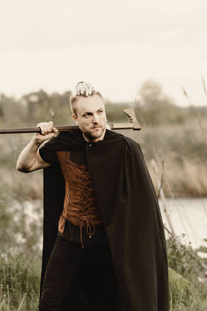 istock A young man with an interesting depicts a Viking with an ax in an unreliable stylized modern costume 1344561402