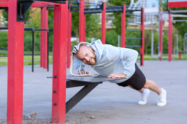 istock A man with an interesting mohawk hairstyle doing push-ups on the street 1344562104