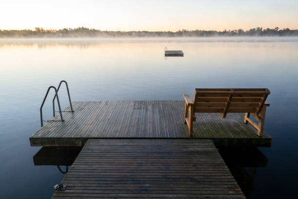 istock boat dock with bench by a foggy lake 1344562352